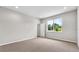Bright bedroom featuring neutral walls, carpet, and a window offering natural light and outdoor views at 4550 Fairway Oaks Dr, Mulberry, FL 33860