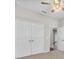 A spacious bedroom featuring neutral walls, a ceiling fan, and a double door closet at 4550 Fairway Oaks Dr, Mulberry, FL 33860
