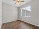 Bedroom with wood flooring, ceiling fan, and a window providing natural light at 4550 Fairway Oaks Dr, Mulberry, FL 33860