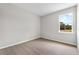 Bright bedroom with plush carpet and a large window overlooking a green outdoor area at 4550 Fairway Oaks Dr, Mulberry, FL 33860