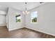 Bright dining area enhanced by hardwood floors, chandelier, and views of the serene outdoors at 4550 Fairway Oaks Dr, Mulberry, FL 33860