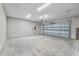 Spacious garage featuring concrete floors, ample lighting, and an automatic door at 4550 Fairway Oaks Dr, Mulberry, FL 33860