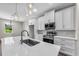 Bright kitchen features modern stainless steel appliances, white cabinets, and a quartz countertop island at 4550 Fairway Oaks Dr, Mulberry, FL 33860