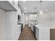 Kitchen features stainless steel appliances, quartz countertops, and an island, creating a modern design at 4550 Fairway Oaks Dr, Mulberry, FL 33860