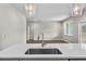 Modern kitchen features a quartz countertop island, stainless steel appliances and hardwood floors at 4550 Fairway Oaks Dr, Mulberry, FL 33860