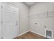 Practical laundry room with modern flooring, shelving and washer/dryer hookups at 4550 Fairway Oaks Dr, Mulberry, FL 33860