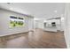 Open concept living space with hardwood floors, large windows, and modern finishes at 4550 Fairway Oaks Dr, Mulberry, FL 33860