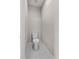Compact powder room featuring a toilet and a stylish hexagon tile floor at 4550 Fairway Oaks Dr, Mulberry, FL 33860