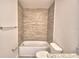 Cozy bathroom featuring a bathtub, shower, and a granite countertop at 4646 Grandview Glen Dr, Auburndale, FL 33823