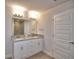 Bathroom featuring double sinks with granite countertops and white cabinets at 4646 Grandview Glen Dr, Auburndale, FL 33823