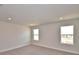 Bright bedroom with neutral walls, carpeted floor, complemented by natural light from two large windows at 4646 Grandview Glen Dr, Auburndale, FL 33823