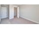 Well-lit room with neutral walls, carpet, base trim and large closet with double doors at 4646 Grandview Glen Dr, Auburndale, FL 33823