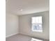 Bright bedroom featuring neutral walls, carpet and a window offering a view of the neighborhood at 4646 Grandview Glen Dr, Auburndale, FL 33823