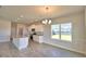 Elegant dining room with a stylish chandelier, bright windows, and easy access to the modern kitchen at 4646 Grandview Glen Dr, Auburndale, FL 33823