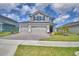 Stunning two-story home featuring a three-car garage and lush landscaping at 4646 Grandview Glen Dr, Auburndale, FL 33823