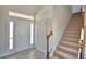 Bright foyer featuring tile flooring, staircase, and natural light at 4646 Grandview Glen Dr, Auburndale, FL 33823