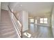 Inviting foyer showcasing a staircase with carpet runner and open-concept floor plan at 4646 Grandview Glen Dr, Auburndale, FL 33823