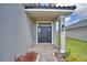 Inviting front entrance with a covered porch and elegant brick pathway at 4646 Grandview Glen Dr, Auburndale, FL 33823