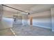 Spacious two-car garage with automatic door, light gray concrete flooring, and plenty of room for parking at 4646 Grandview Glen Dr, Auburndale, FL 33823