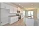 Modern kitchen featuring white cabinets, stainless steel appliances, and a granite island at 4646 Grandview Glen Dr, Auburndale, FL 33823