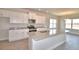 Modern kitchen with granite countertops, stainless steel appliances, a large island, and bright, natural lighting at 4646 Grandview Glen Dr, Auburndale, FL 33823