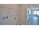 Functional laundry room with modern appliances connections, ample shelving, and conveniently located near the kitchen at 4646 Grandview Glen Dr, Auburndale, FL 33823
