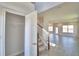 Open-concept living space with tile floors, ample natural light, and staircase at 4646 Grandview Glen Dr, Auburndale, FL 33823