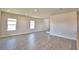 Bright and spacious living room features wood-look tile floors and natural light at 4646 Grandview Glen Dr, Auburndale, FL 33823