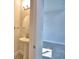 Cozy powder room featuring a pedestal sink and elegant mirror at 4646 Grandview Glen Dr, Auburndale, FL 33823