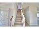 Carpeted staircase with wood railing, leading to the upper level of the home at 4646 Grandview Glen Dr, Auburndale, FL 33823