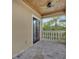 Charming balcony features stone floors, ceiling fan, and views of the tropical landscaping at 6487 Ashley Dr, Lakeland, FL 33813