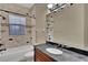 Bathroom featuring a tiled shower with built-in shelves, a dark countertop and chrome fixtures at 6487 Ashley Dr, Lakeland, FL 33813