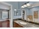 Granite countertop and under-mount sink in bathroom with tile accents, large mirror, and lighting at 6487 Ashley Dr, Lakeland, FL 33813