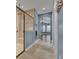 Bathroom featuring a glass shower with a bench and a view into the bedroom at 6487 Ashley Dr, Lakeland, FL 33813