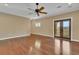This bedroom features hardwood floors, crown molding, a ceiling fan and access to a balcony at 6487 Ashley Dr, Lakeland, FL 33813