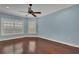 Bright bedroom featuring hardwood floors, blue walls, crown molding, and modern ceiling fan at 6487 Ashley Dr, Lakeland, FL 33813