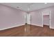A spacious bedroom featuring hardwood floors, a closet, and an en-suite bathroom at 6487 Ashley Dr, Lakeland, FL 33813