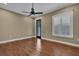 Bedroom featuring hardwood floors, a ceiling fan, and a window with plantation shutters at 6487 Ashley Dr, Lakeland, FL 33813