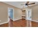 Spacious bedroom with hardwood floors, ceiling fan, a built in niche, and neutral paint at 6487 Ashley Dr, Lakeland, FL 33813