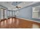 Spacious bedroom with hardwood floors, tray ceiling, plantation shutters, and ceiling fan at 6487 Ashley Dr, Lakeland, FL 33813