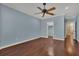 Bedroom features wood floors, a ceiling fan, and a view to walk-in closet at 6487 Ashley Dr, Lakeland, FL 33813
