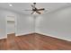 A spacious bedroom featuring hardwood floors, a closet, and an en-suite bathroom at 6487 Ashley Dr, Lakeland, FL 33813