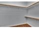 Walk-in closet with wood shelving, offering ample storage space at 6487 Ashley Dr, Lakeland, FL 33813