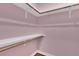 Walk-in closet is complete with shelves and wooden closet rods at 6487 Ashley Dr, Lakeland, FL 33813