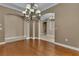 Spacious dining area featuring hardwood floors, elegant lighting, and decorative archways to adjacent rooms at 6487 Ashley Dr, Lakeland, FL 33813