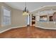 Well-lit dining room shows hardwood floors and is adjacent to the kitchen and breakfast bar at 6487 Ashley Dr, Lakeland, FL 33813