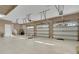 Spacious three car garage features bright lighting, tile flooring, and a baseball practice net at 6487 Ashley Dr, Lakeland, FL 33813