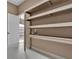 Garage featuring custom shelves and storage with entry door view at 6487 Ashley Dr, Lakeland, FL 33813