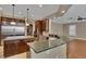 Elegant kitchen featuring dark wood cabinetry, large island with granite countertop, and stainless steel appliances at 6487 Ashley Dr, Lakeland, FL 33813