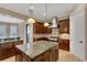 The gourmet kitchen offers an island with granite countertops, stainless steel appliances, and custom cabinetry at 6487 Ashley Dr, Lakeland, FL 33813